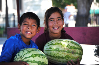 Two kids with watermelons