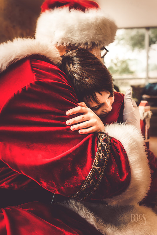 Child hugging Santa